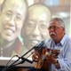 German singer and former GDR dissident Wolf Biermann performs during a memorial event to mark the first anniversary of Liu Xiaobo’s death in Berlin, July 13, 2018. The photo in the background shows Liu with his wife Liu Xia.